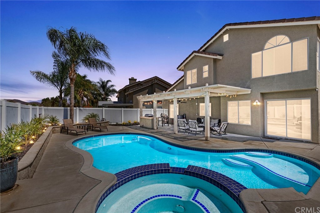a view of a house with swimming pool and sitting area