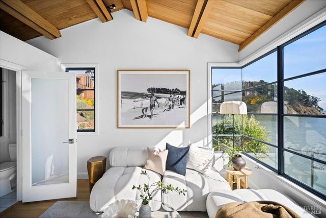 a kitchen with stainless steel appliances granite countertop a table chairs stove and refrigerator