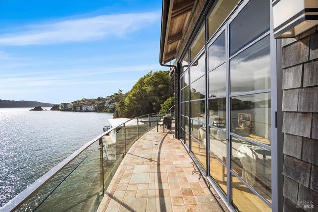 a living room with furniture a floor to ceiling window and potted plant