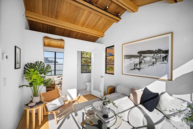 a bedroom with furniture and a large window