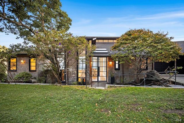 a view of a house with a backyard