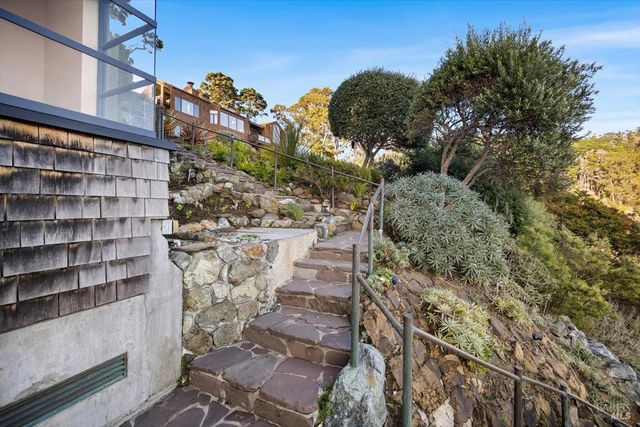 a view of a hallway with wooden floor and entryway