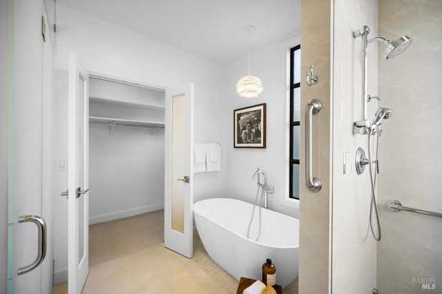 a kitchen with stainless steel appliances granite countertop a stove top oven a sink and a dining table with wooden floor