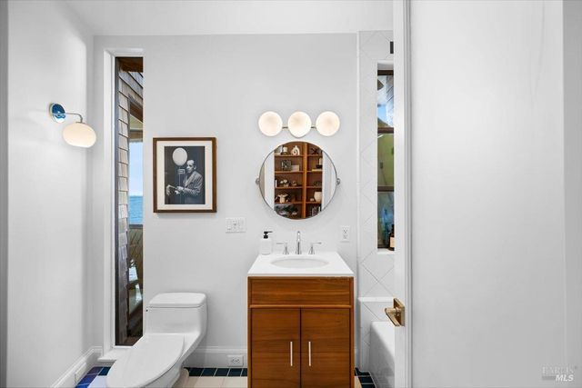 a living room with furniture a dining table and chairs