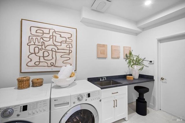 a kitchen with stainless steel appliances granite countertop a stove a refrigerator and a sink