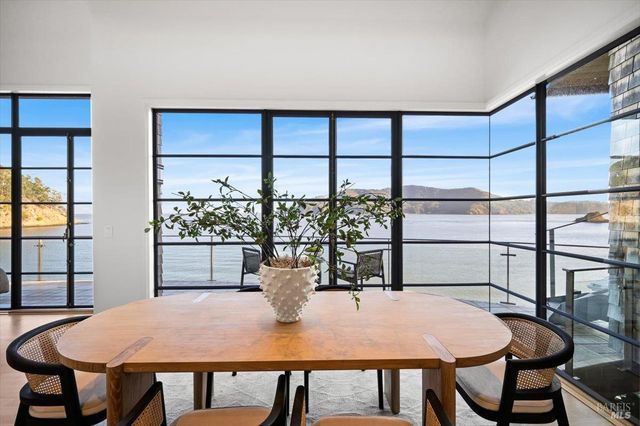 a view of a hallway with wooden floor and a bathroom