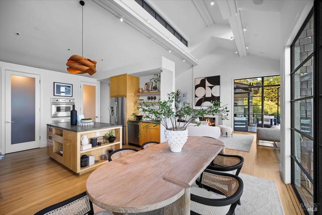a living room with furniture fireplace and a large window