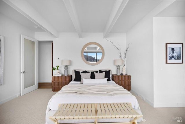 a living room with furniture a fireplace and a window