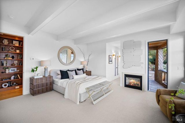 a spacious bedroom with a bed and a large window