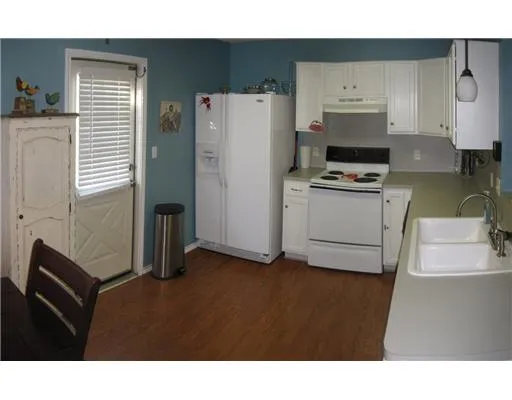 a kitchen with a refrigerator and a stove