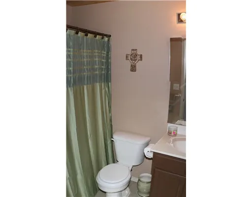 a white toilet sitting next to a bathroom sink and vanity