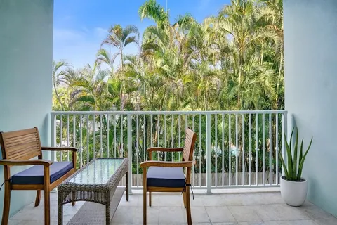 a view of a chairs and table in the balcony