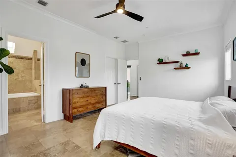 a bedroom with a bed and ceiling fan