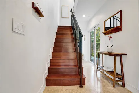 a view of entryway and hall with wooden floor