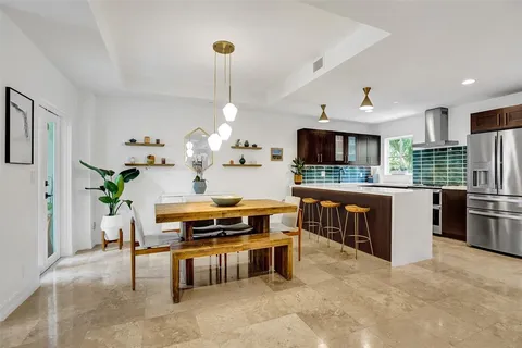 a living room with stainless steel appliances kitchen island granite countertop furniture and a view of kitchen