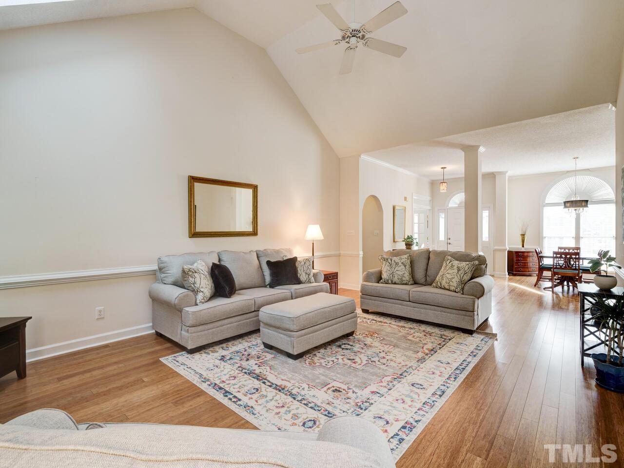 12108 Amoretto Way Raleigh, NC 27613 - Photo 16 of 40 a living room with furniture and a wooden floor