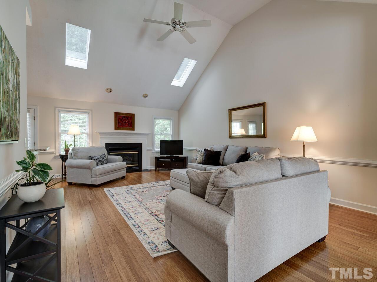 12108 Amoretto Way Raleigh, NC 27613 - Photo 18 of 40 a living room with furniture and a fireplace