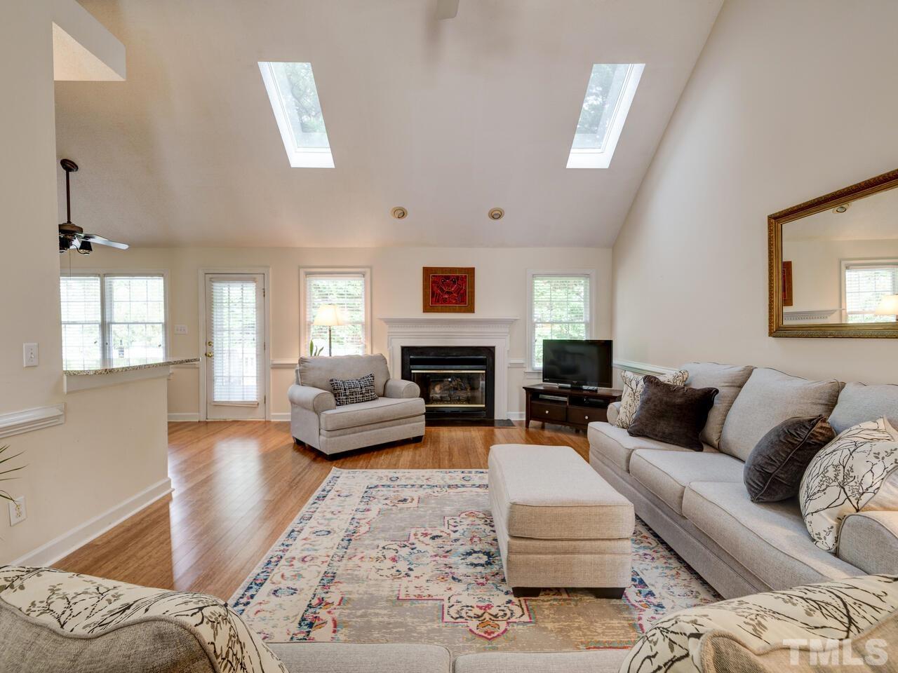 12108 Amoretto Way Raleigh, NC 27613 - Photo 20 of 40 a living room with furniture fireplace and a window