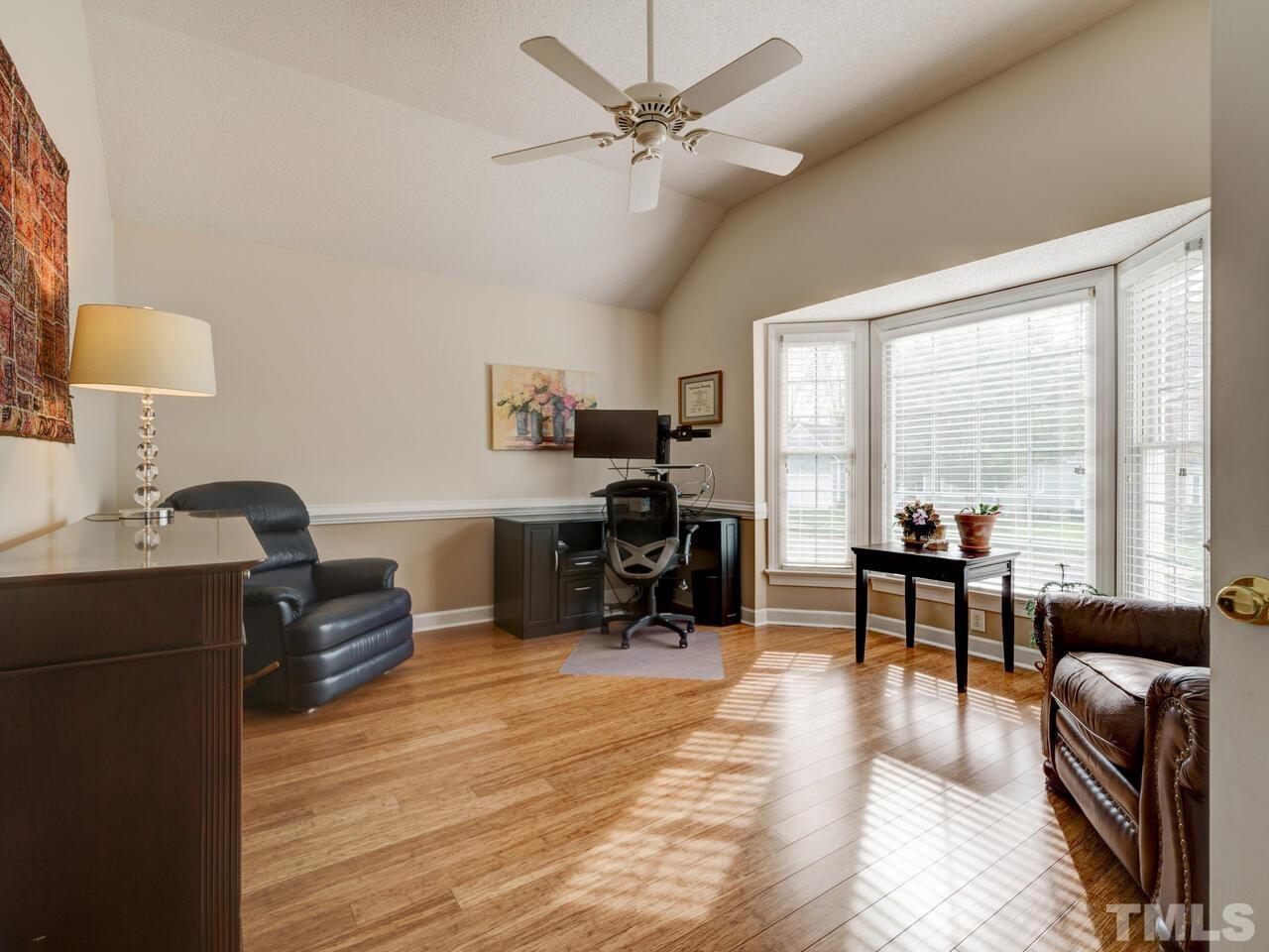 12108 Amoretto Way Raleigh, NC 27613 - Photo 21 of 40 a work room with furniture and wooden floor