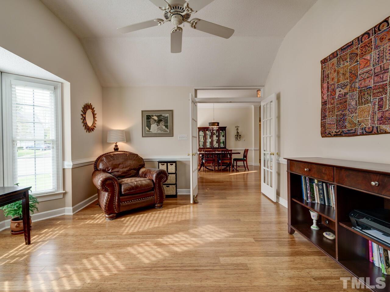 12108 Amoretto Way Raleigh, NC 27613 - Photo 22 of 40 a living room with furniture and a flat screen tv