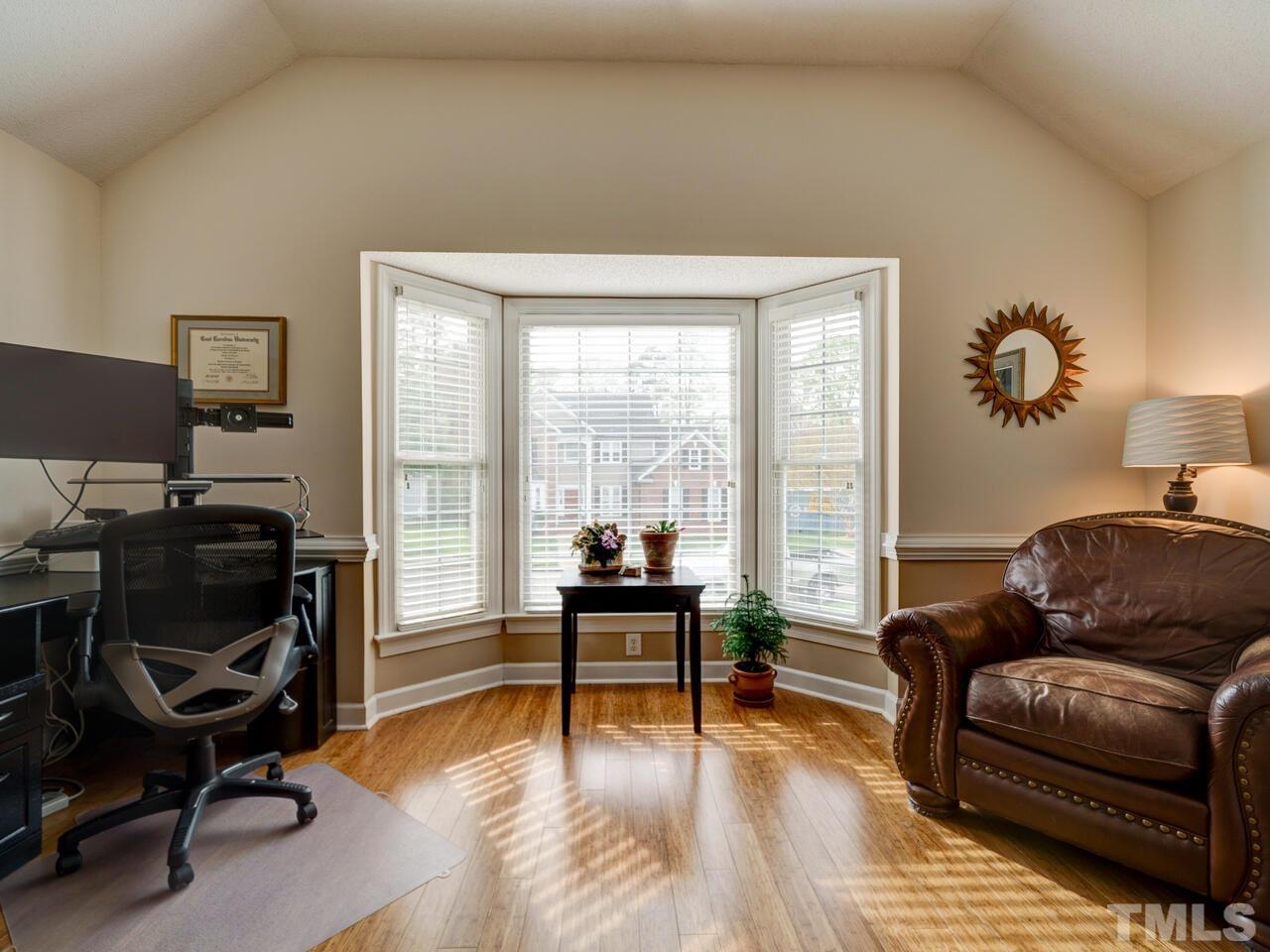 12108 Amoretto Way Raleigh, NC 27613 - Photo 23 of 40 a living room with furniture and a wooden floor