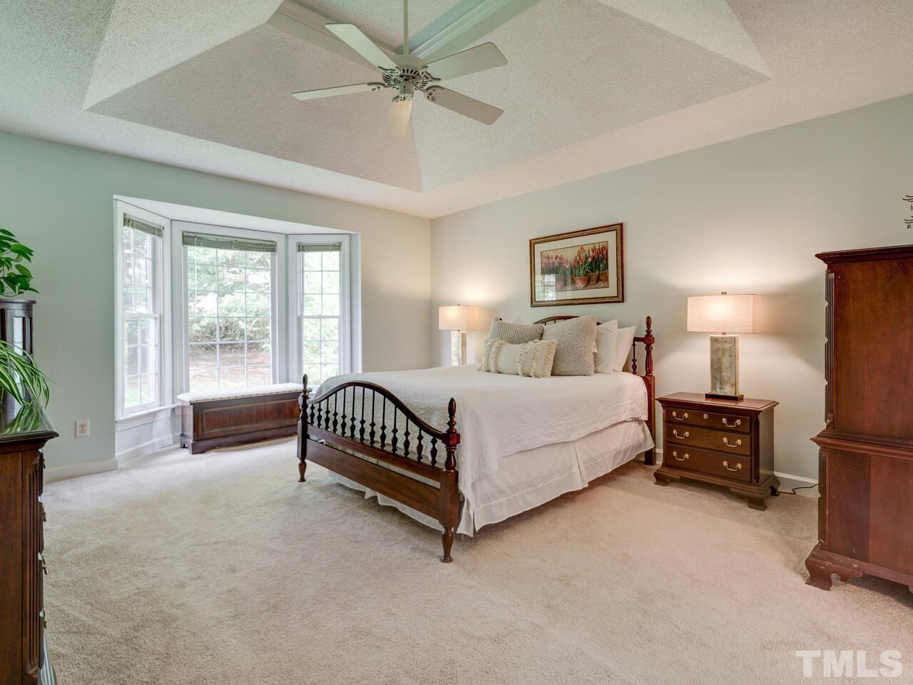 12108 Amoretto Way Raleigh, NC 27613 - Photo 25 of 40 a spacious bedroom with a bed and a window