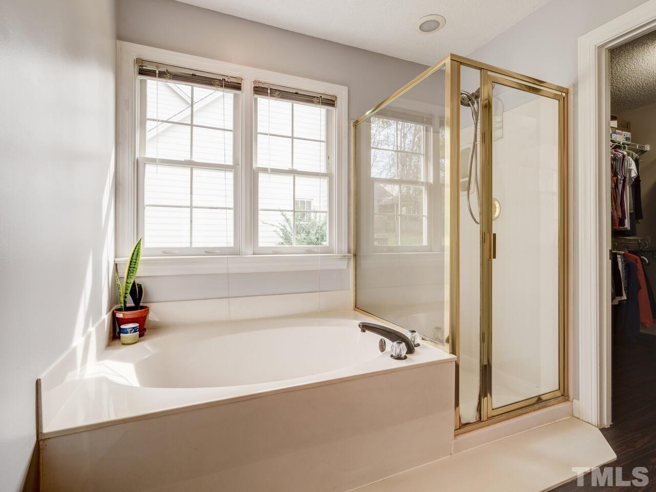 12108 Amoretto Way Raleigh, NC 27613 - Photo 27 of 40 a bathroom with a bathtub and a shower