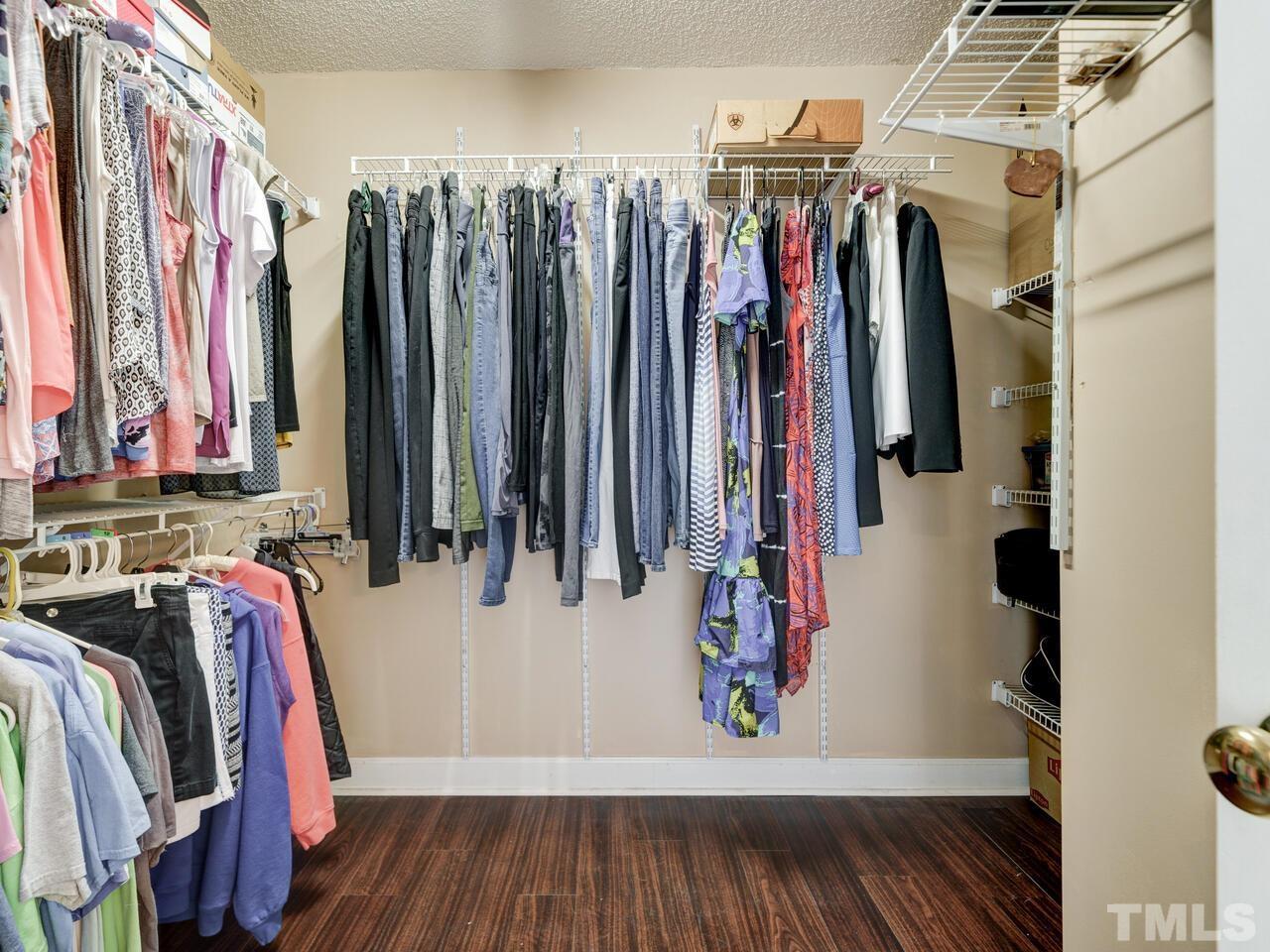 12108 Amoretto Way Raleigh, NC 27613 - Photo 29 of 40 a view of walk in closet with clothes and shoes