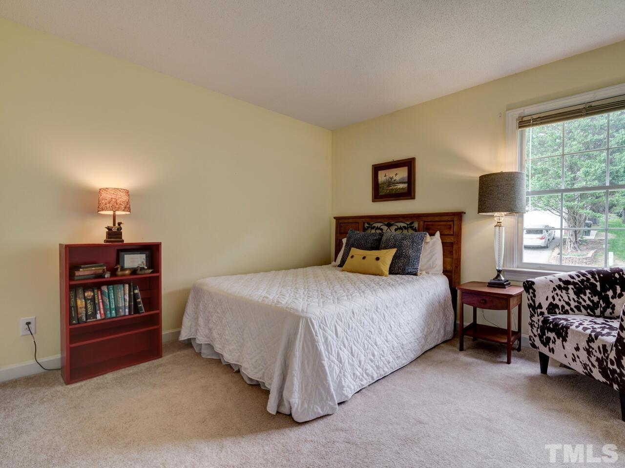 12108 Amoretto Way Raleigh, NC 27613 - Photo 30 of 40 a bedroom with a bed furniture and a window