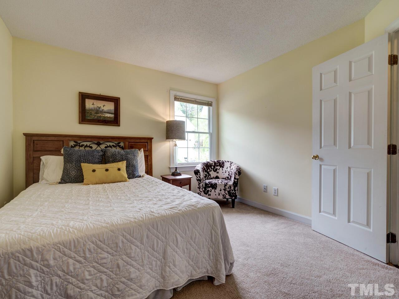 12108 Amoretto Way Raleigh, NC 27613 - Photo 31 of 40 a bedroom with a bed and a window