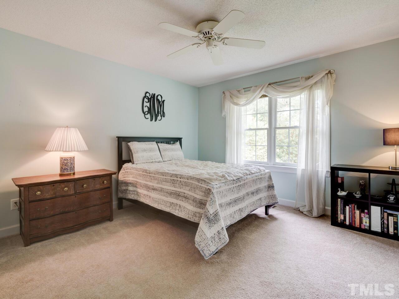 12108 Amoretto Way Raleigh, NC 27613 - Photo 32 of 40 a bedroom with a bed dresser and a window