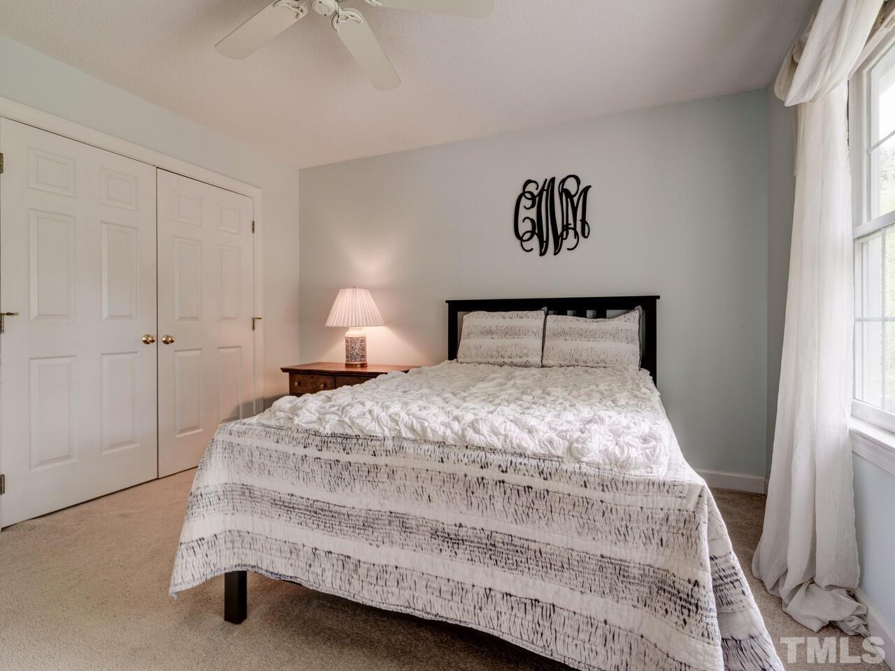 12108 Amoretto Way Raleigh, NC 27613 - Photo 33 of 40 a bedroom with a bed and a window