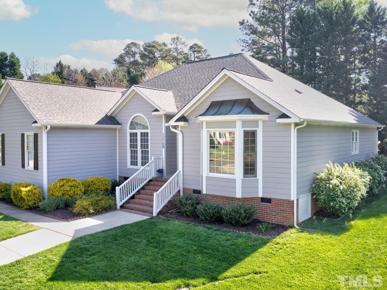 12108 Amoretto Way Raleigh, NC 27613 - Photo 40 of 40 a front view of a house with a yard and outdoor seating