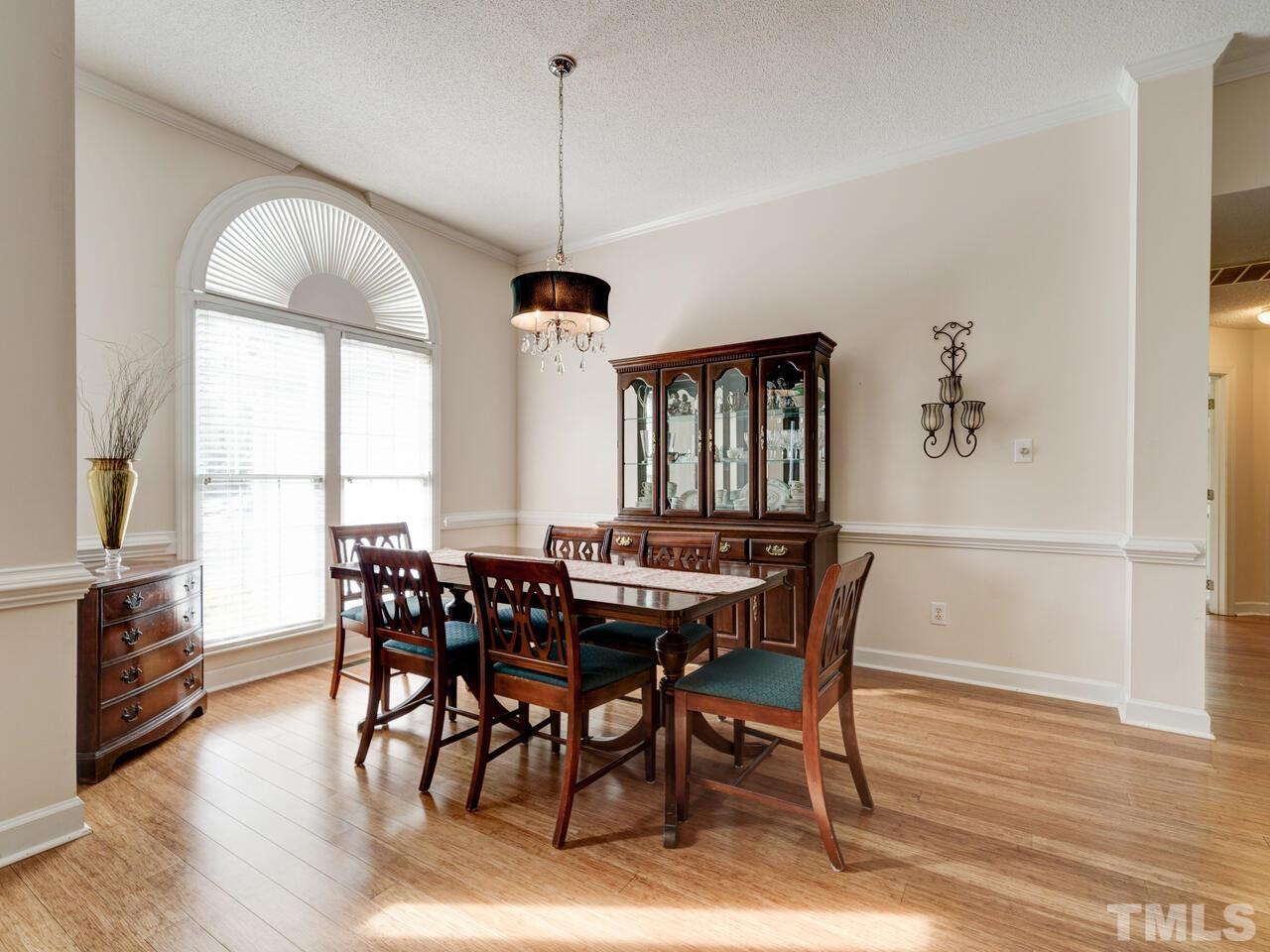 12108 Amoretto Way Raleigh, NC 27613 - Photo 4 of 40 a view of a dining room with furniture window and wooden floor