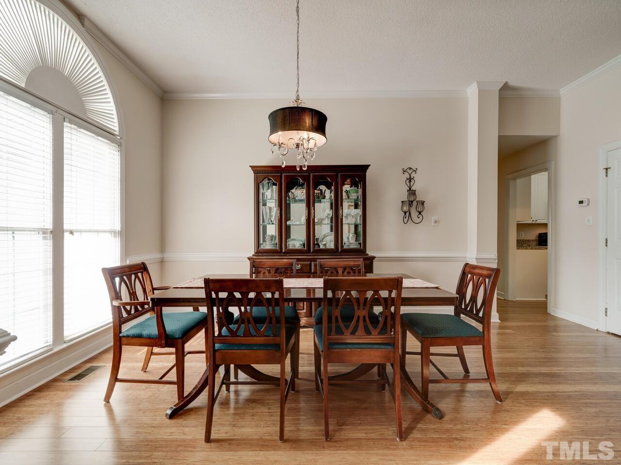 12108 Amoretto Way Raleigh, NC 27613 - Photo 5 of 40 a view of a dining room with furniture window and wooden floor