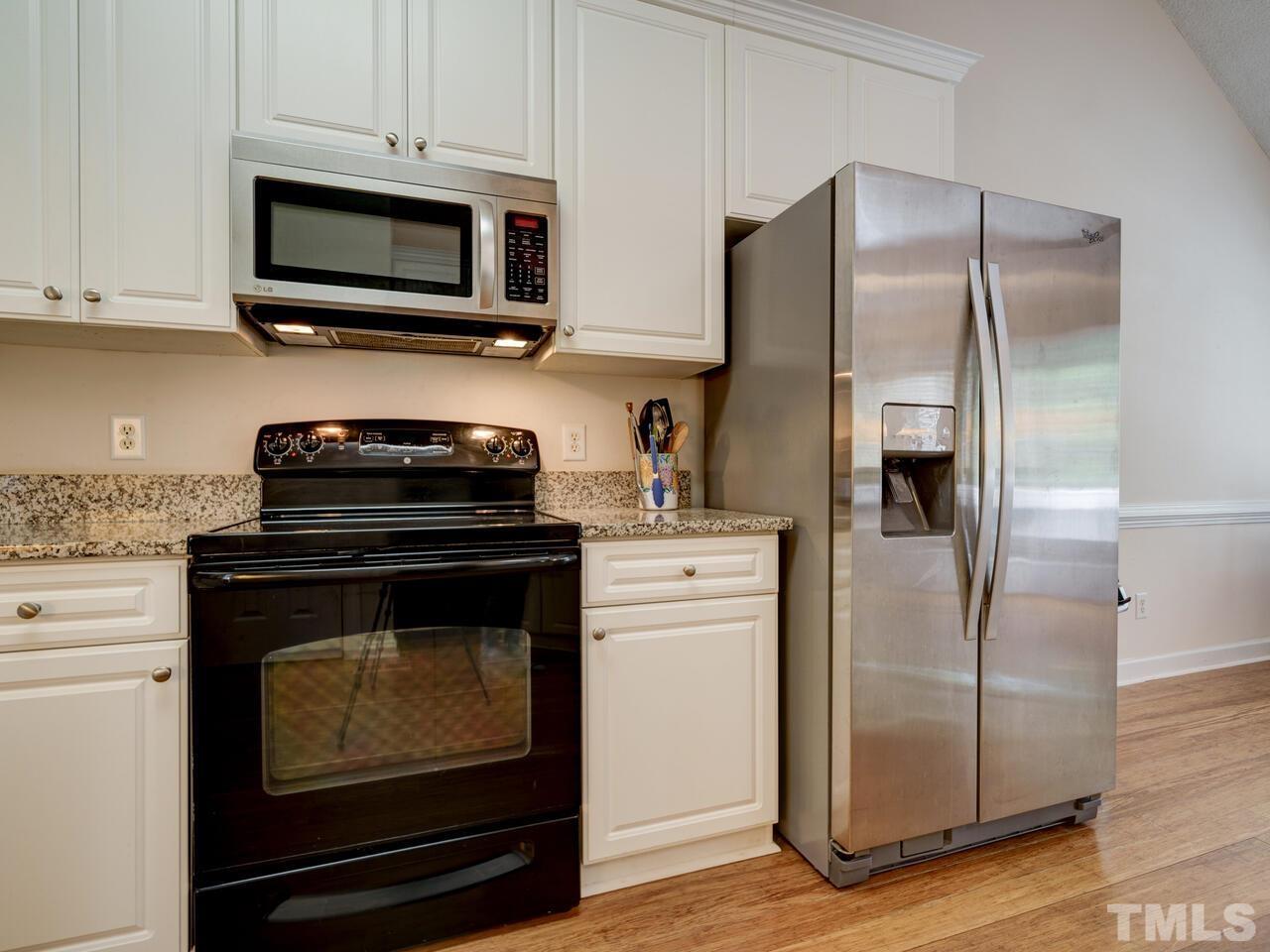 12108 Amoretto Way Raleigh, NC 27613 - Photo 7 of 40 a kitchen with a refrigerator stove and microwave