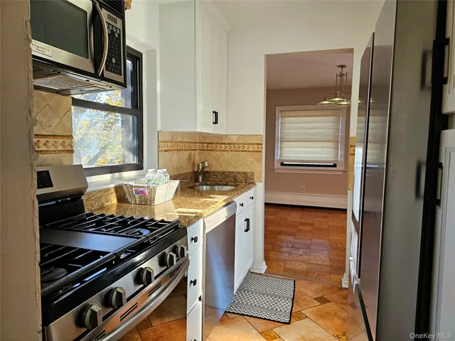 a kitchen with wooden cabinets and a stove top oven