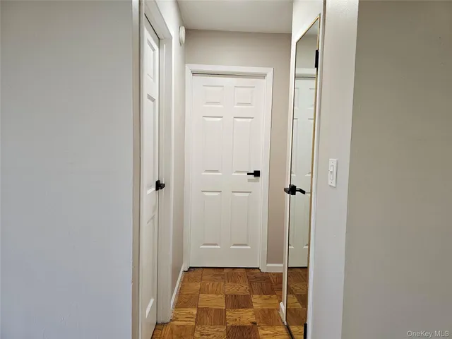 an empty room with wooden floor and window