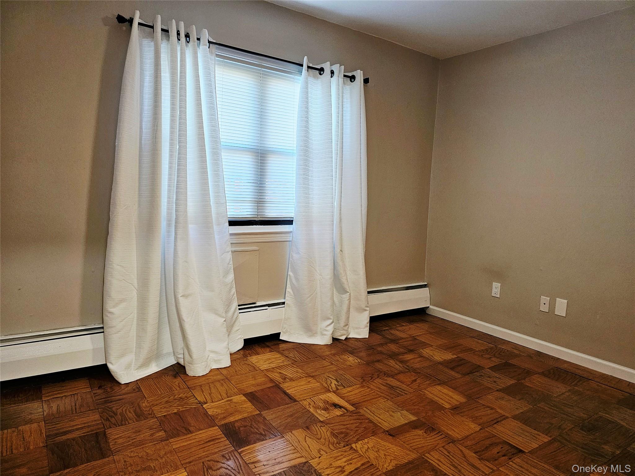 2261 Palmer Avenue, Unit 3C New Rochelle, NY 10801 - Photo 17 of 23 a view of a room with wooden floor and a window