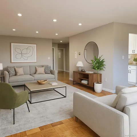 a living room with furniture a potted plant and a fireplace