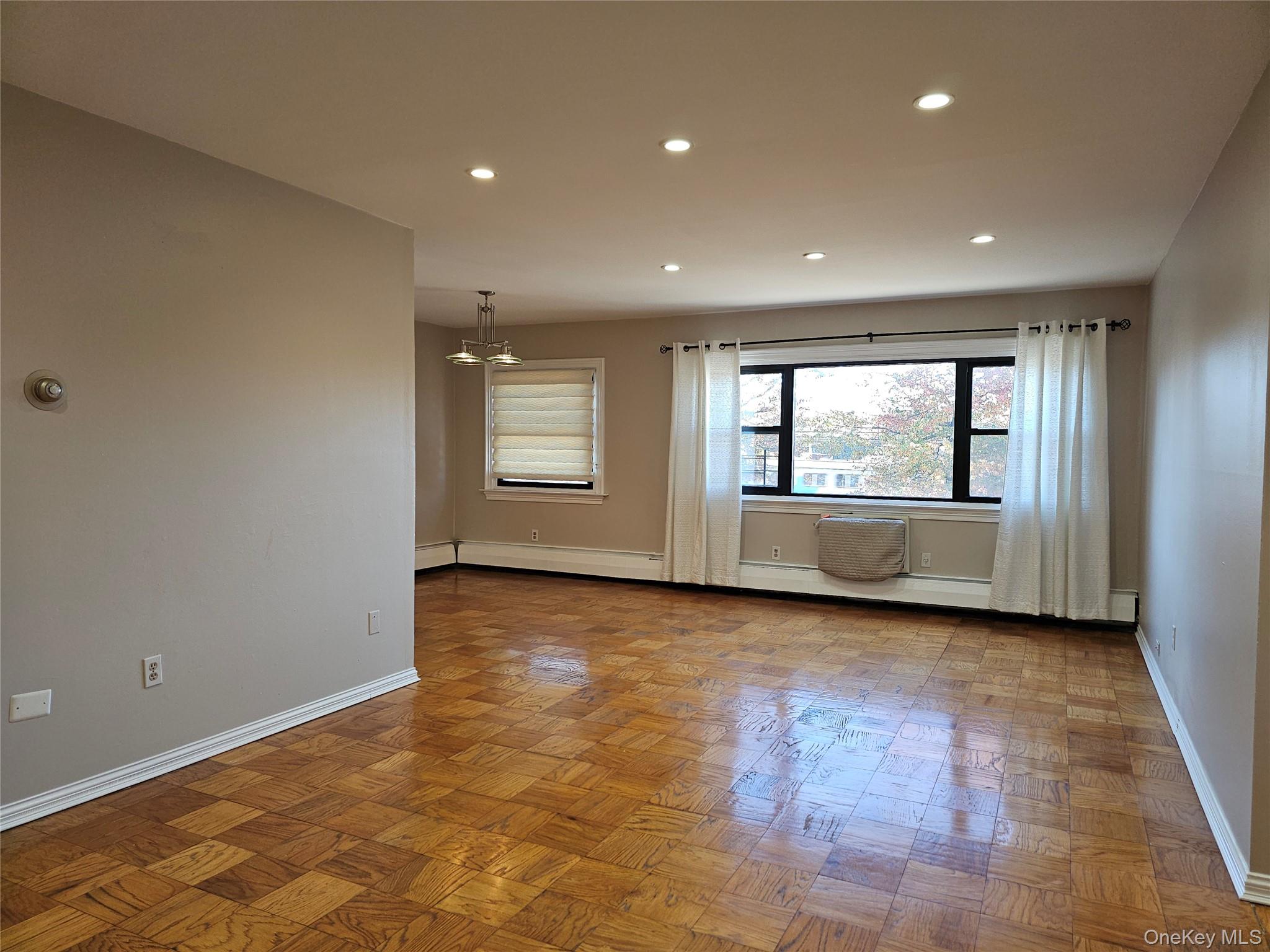 2261 Palmer Avenue, Unit 3C New Rochelle, NY 10801 - Photo 6 of 23 a view of an empty room with wooden floor and a window