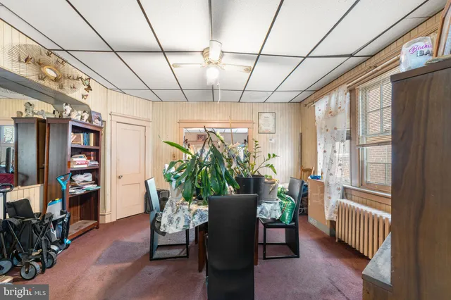 a dining room with furniture window and wooden floor