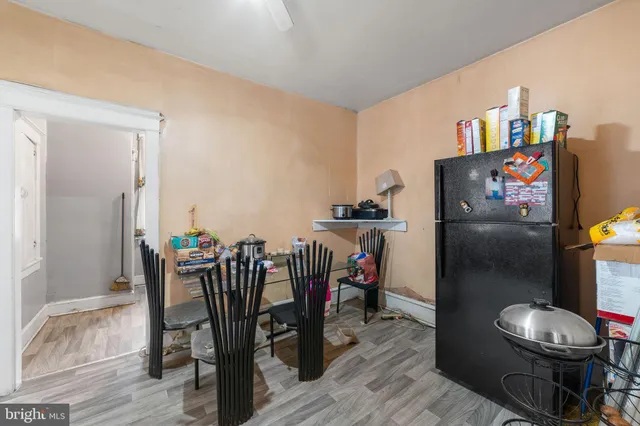 a dining room with furniture and wooden floor