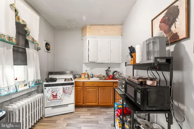 a view of kitchen with stainless steel appliances granite countertop a stove a sink and a refrigerator