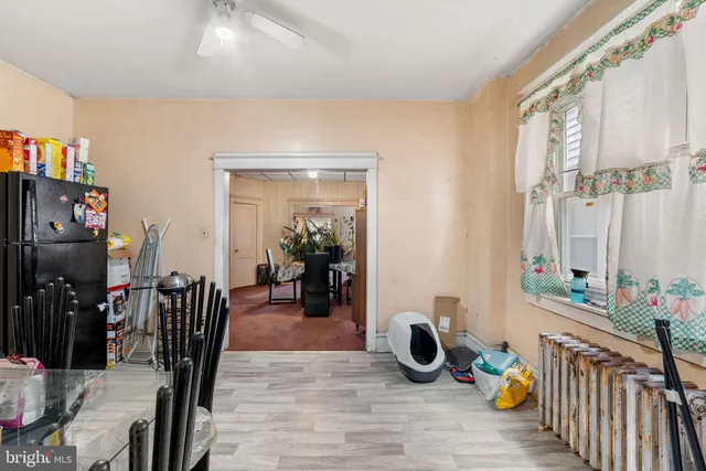 a view of a livingroom with furniture and bedroom