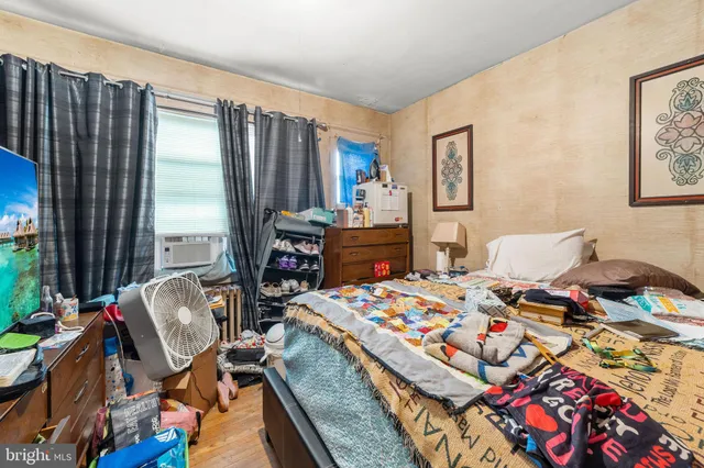 a bedroom that has a bed and a chair in it