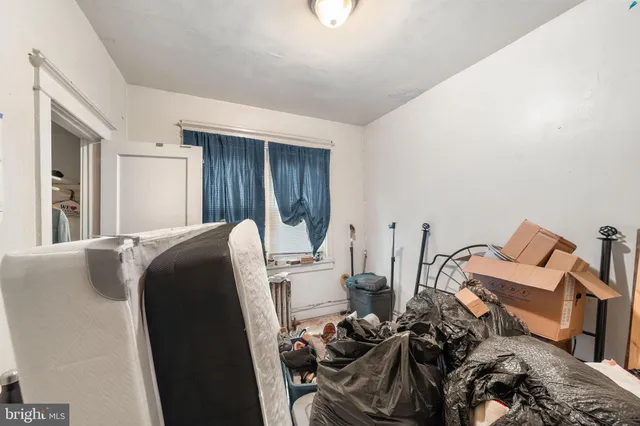 a bed room with a bed and a window