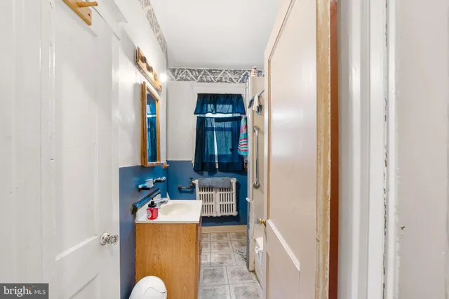 a view of living room with a baby crib furniture and a window