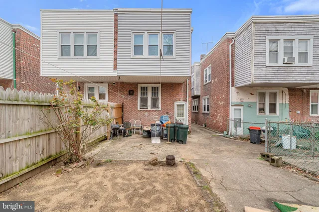a backyard of a house with yard outdoor seating and barbeque oven