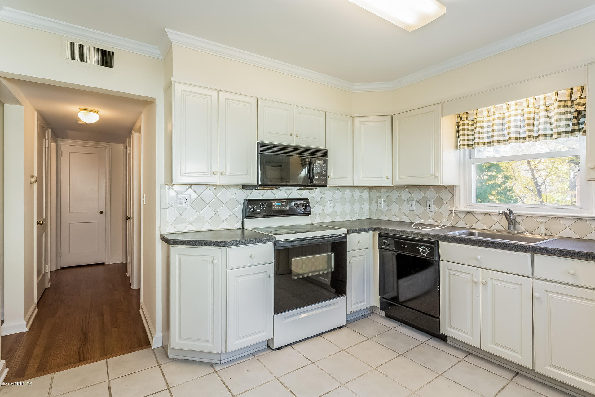 34 Wescott Street Riverside, CT 06878 - Photo 10 of 26 a kitchen with granite countertop white cabinets and white appliances